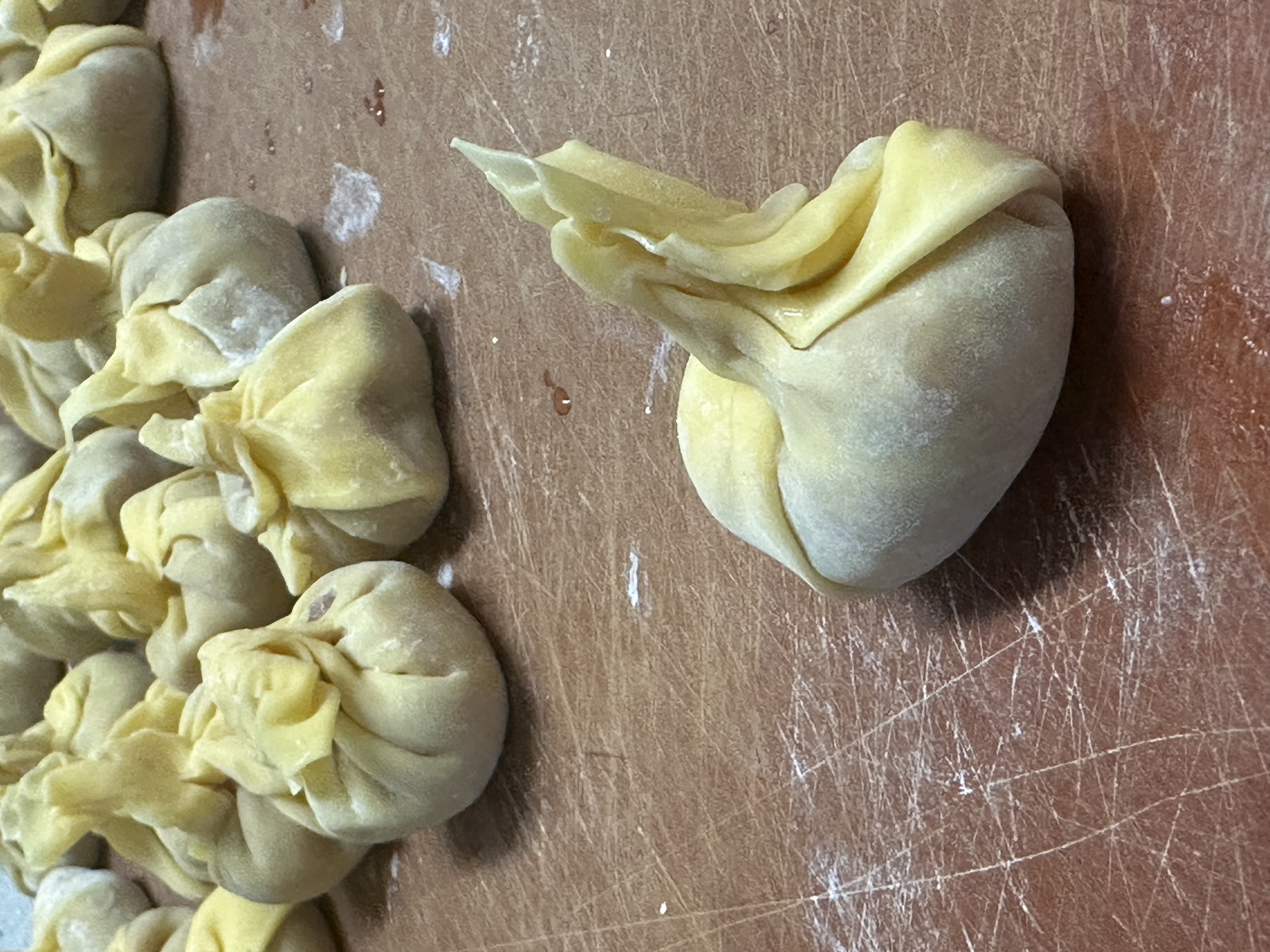 Photo of the former triangle folded up into a little purse/radish looking thing